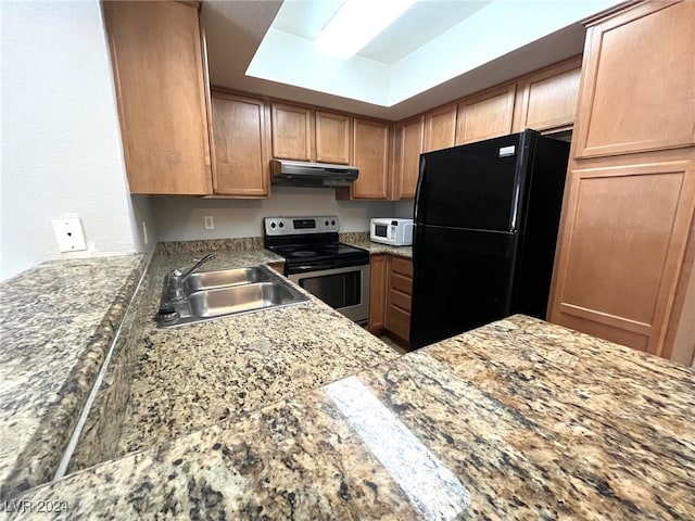 kitchen featuring black fridge, sink, and electric range