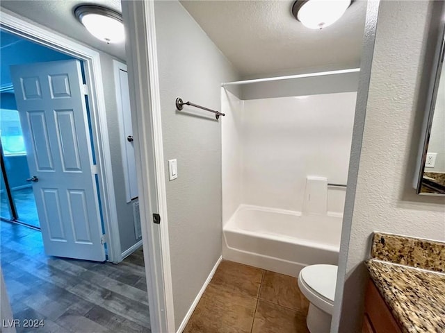 full bathroom with tile patterned floors, vanity, toilet, and washtub / shower combination