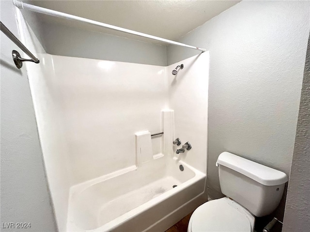 bathroom featuring toilet and shower / bath combination