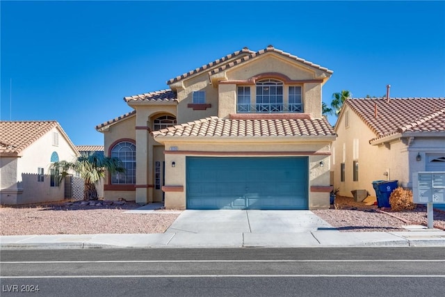 mediterranean / spanish home with a garage