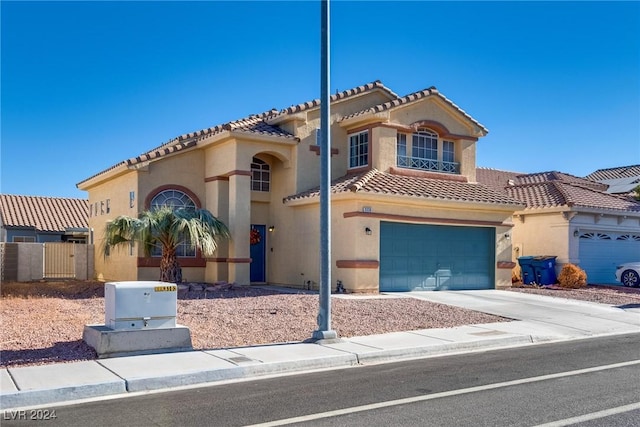 mediterranean / spanish-style house with a garage