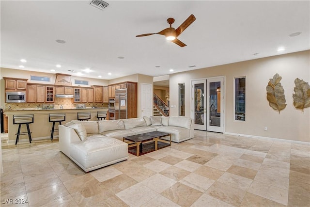 living room with ceiling fan and french doors