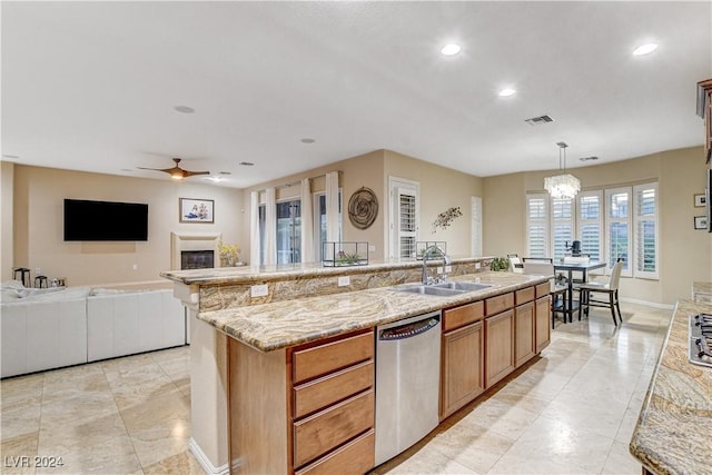 kitchen with dishwasher, hanging light fixtures, a center island with sink, and sink