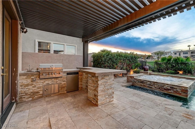 patio terrace at dusk featuring area for grilling, a pergola, sink, and grilling area