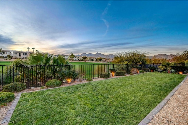 yard at dusk featuring a mountain view