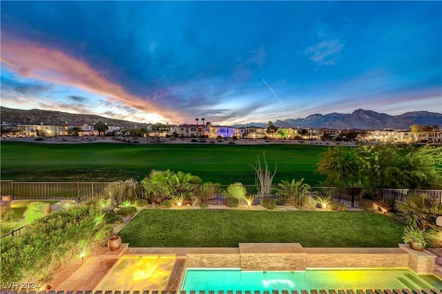 exterior space featuring a mountain view and a lawn