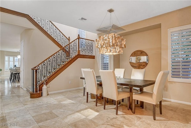 dining area featuring a notable chandelier