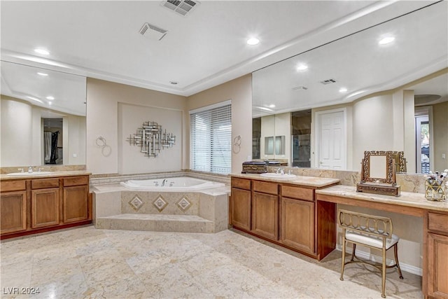 bathroom featuring vanity and tiled tub