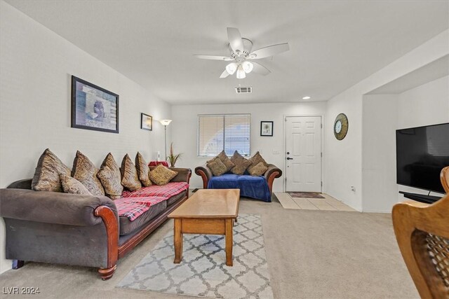 living room with light colored carpet and ceiling fan