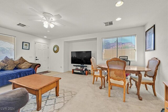 carpeted living room featuring ceiling fan