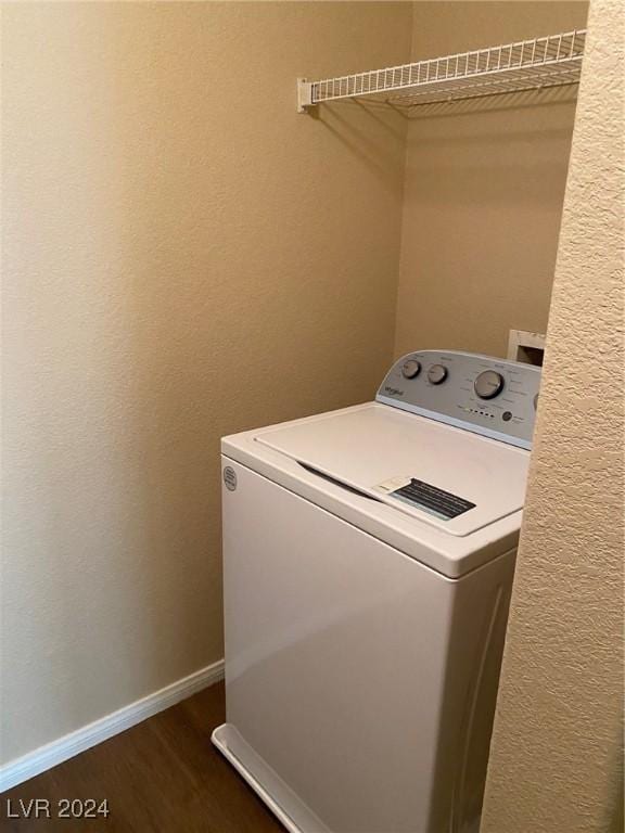 laundry area with dark hardwood / wood-style flooring and washer / dryer