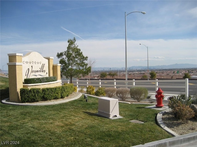 view of community featuring a lawn and a mountain view