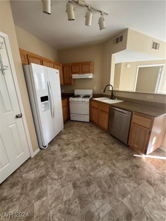 kitchen with sink and white appliances