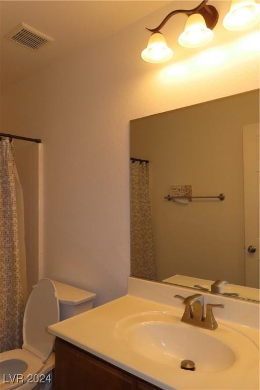 bathroom with vanity, a shower with shower curtain, and toilet