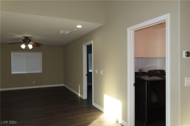 corridor featuring separate washer and dryer and dark wood-type flooring