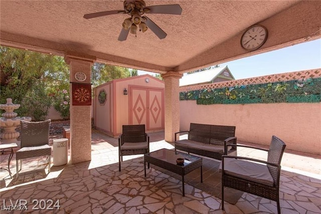 view of patio with outdoor lounge area and a shed