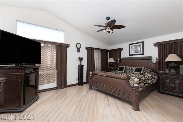 bedroom featuring ceiling fan, light wood-type flooring, and vaulted ceiling