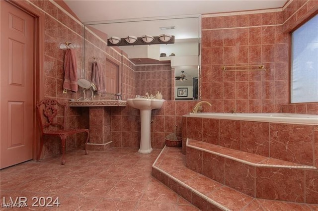 bathroom featuring tiled bath, tile patterned floors, and tile walls