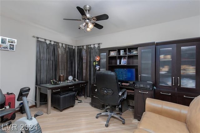 office with light hardwood / wood-style flooring and ceiling fan