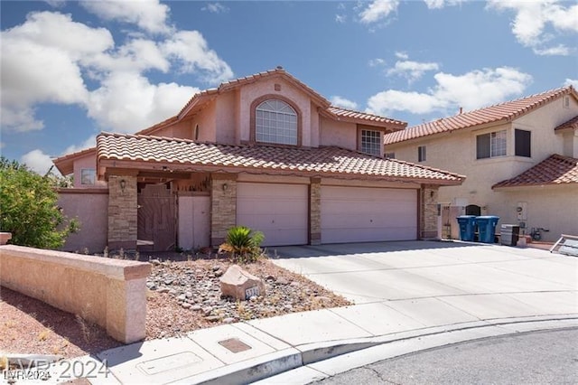 mediterranean / spanish-style house with a garage