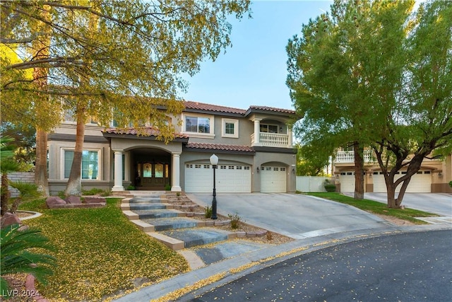 mediterranean / spanish home featuring a garage