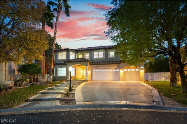 mediterranean / spanish-style home with a garage