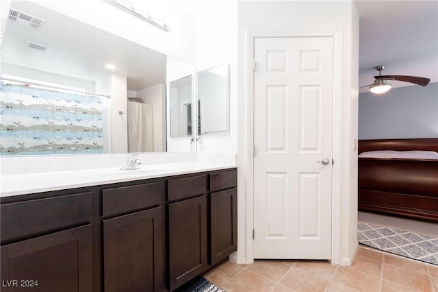 bathroom featuring a shower with curtain, ceiling fan, vanity, and tile patterned flooring