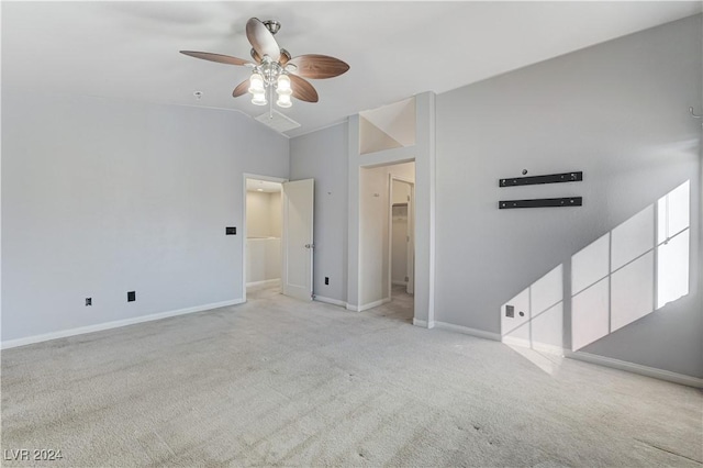 spare room with ceiling fan, light colored carpet, and high vaulted ceiling