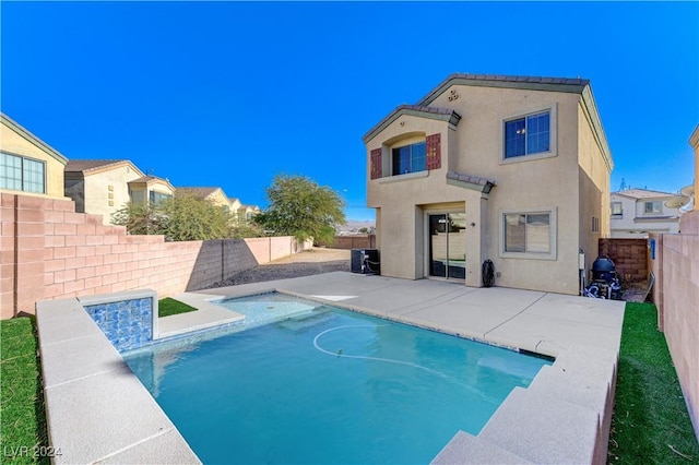 back of house with a fenced in pool