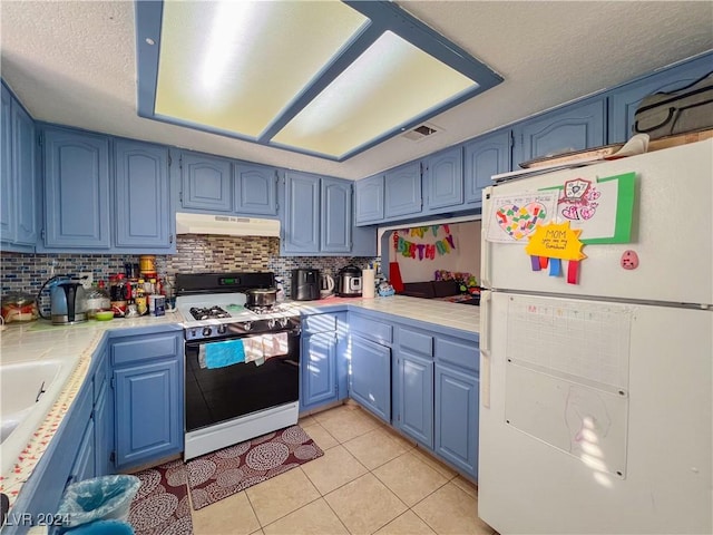 kitchen with blue cabinetry, a textured ceiling, and white appliances