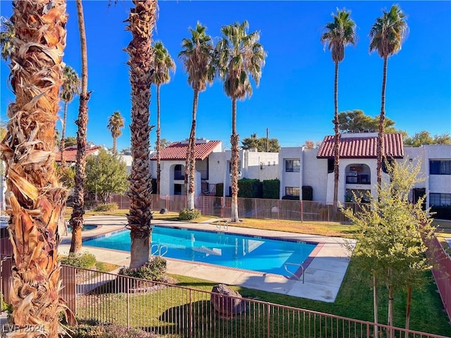 view of swimming pool with a lawn and a patio