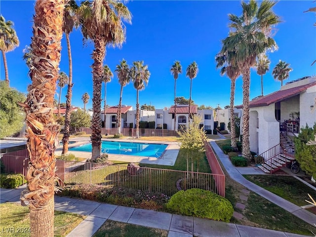 view of pool featuring a yard