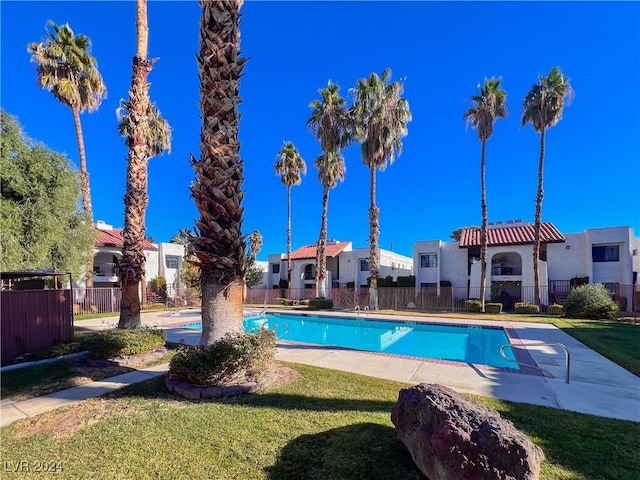 view of pool with a yard