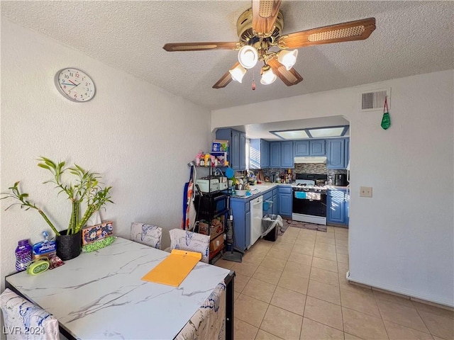 kitchen featuring blue cabinetry, a textured ceiling, white appliances, and backsplash