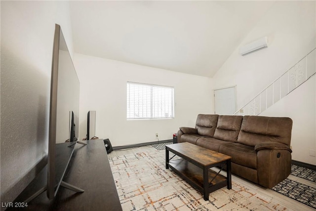 living room with an AC wall unit, light hardwood / wood-style flooring, and high vaulted ceiling