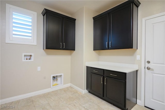 clothes washing area with cabinets, washer hookup, gas dryer hookup, and electric dryer hookup