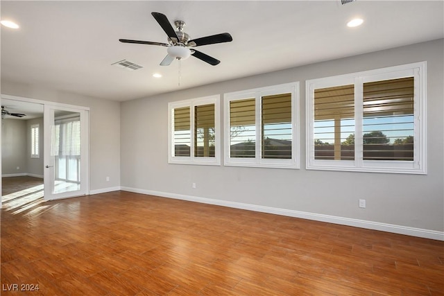 empty room featuring hardwood / wood-style floors and ceiling fan