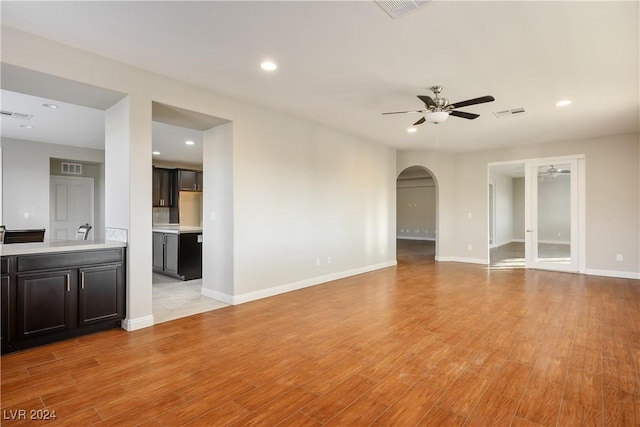 unfurnished living room with light hardwood / wood-style floors and ceiling fan