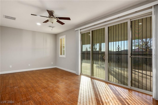 empty room featuring hardwood / wood-style floors and ceiling fan