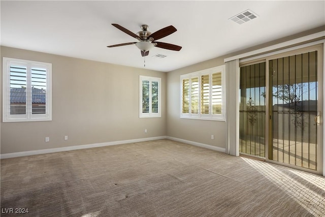 carpeted empty room with ceiling fan