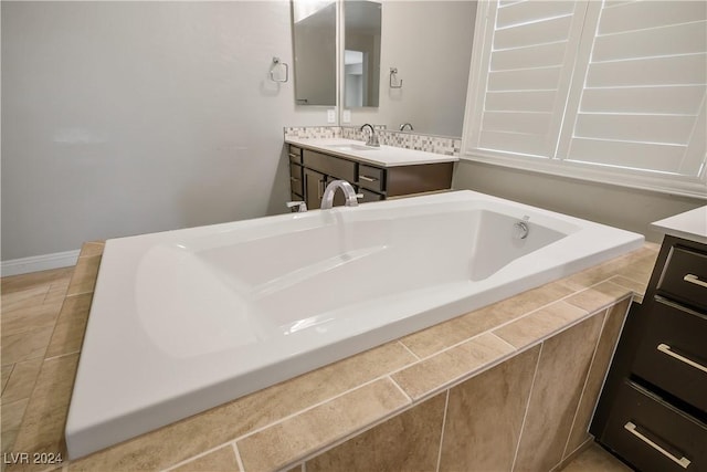 bathroom featuring vanity and a tub to relax in