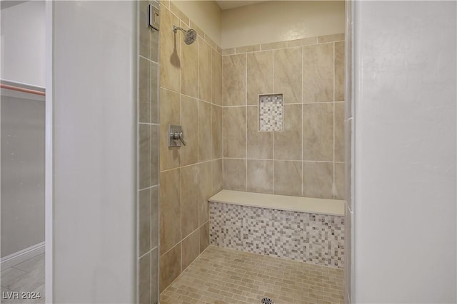 bathroom with a tile shower