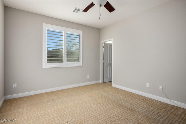 carpeted spare room with ceiling fan