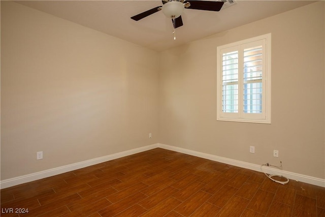 spare room with ceiling fan and dark hardwood / wood-style flooring