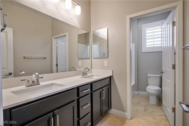 bathroom with tile patterned floors, vanity, and toilet