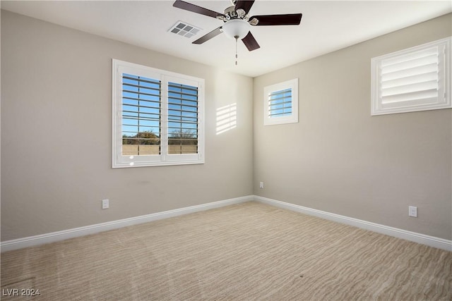 carpeted empty room featuring ceiling fan