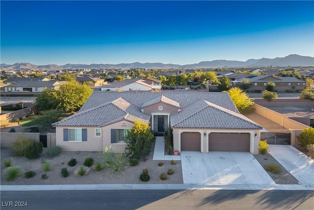 view of front of home featuring a mountain view and a garage