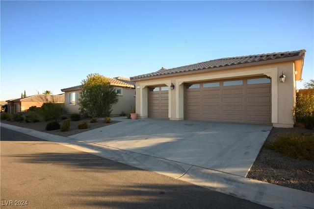 mediterranean / spanish-style home with a garage