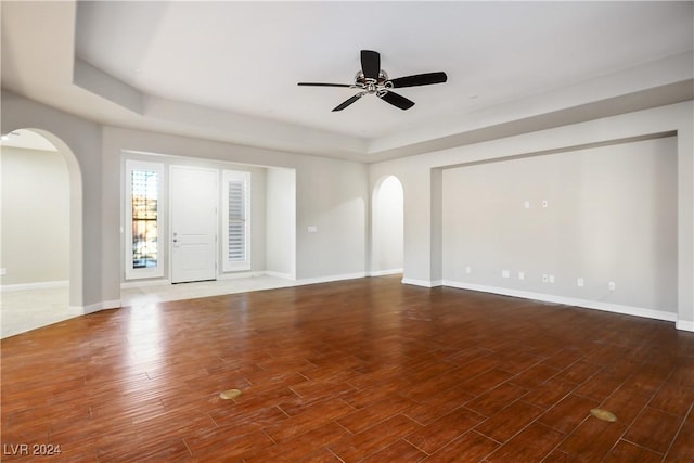 spare room featuring dark hardwood / wood-style flooring and ceiling fan