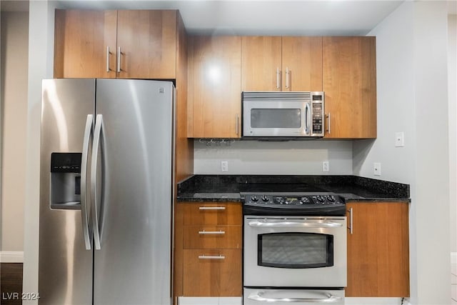 200 W Sahara Ave Unit 1510, Las Vegas, NV 89102 - kitchen featuring appliances with stainless steel finishes, dark stone counters, and brown cabinetry
